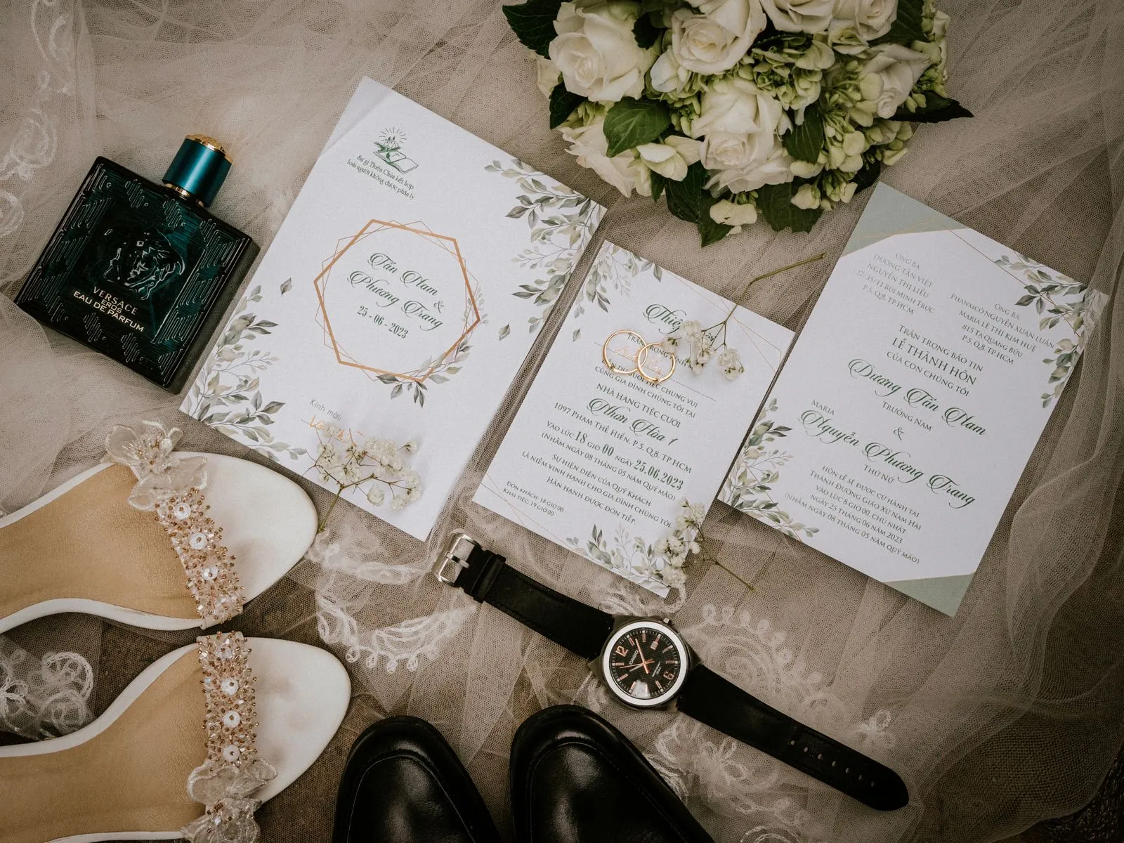 Wedding stationery, shoes and accessories arranged with a bouquet.
