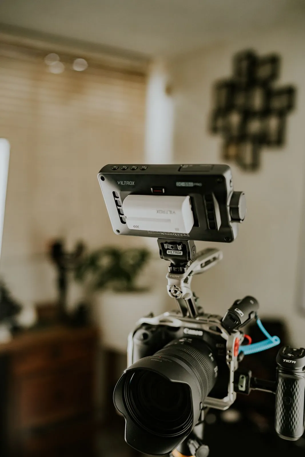 Video camera on a support with an external monitor in a room.