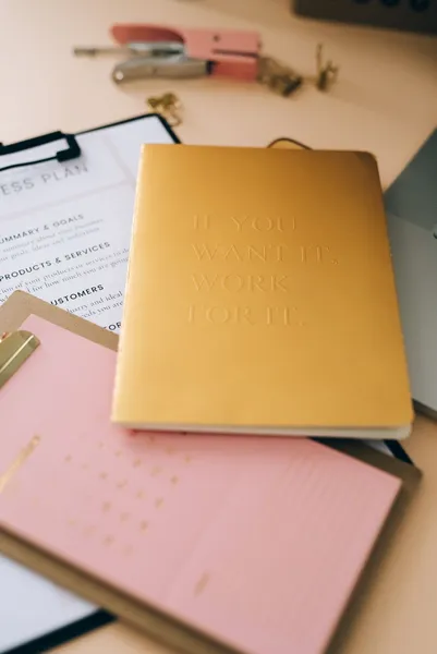Documents on a clipboard with a folder and desk accessories.