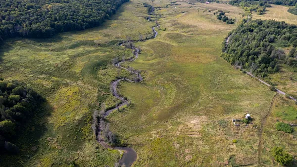 Stunning aerial view of winding river and lush forest in Québec, Canada.