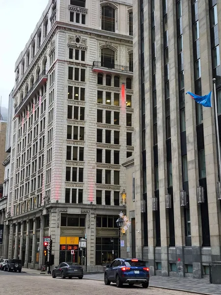 A blend of historic and modern architecture on a street in Montreal, Quebec, Canada.