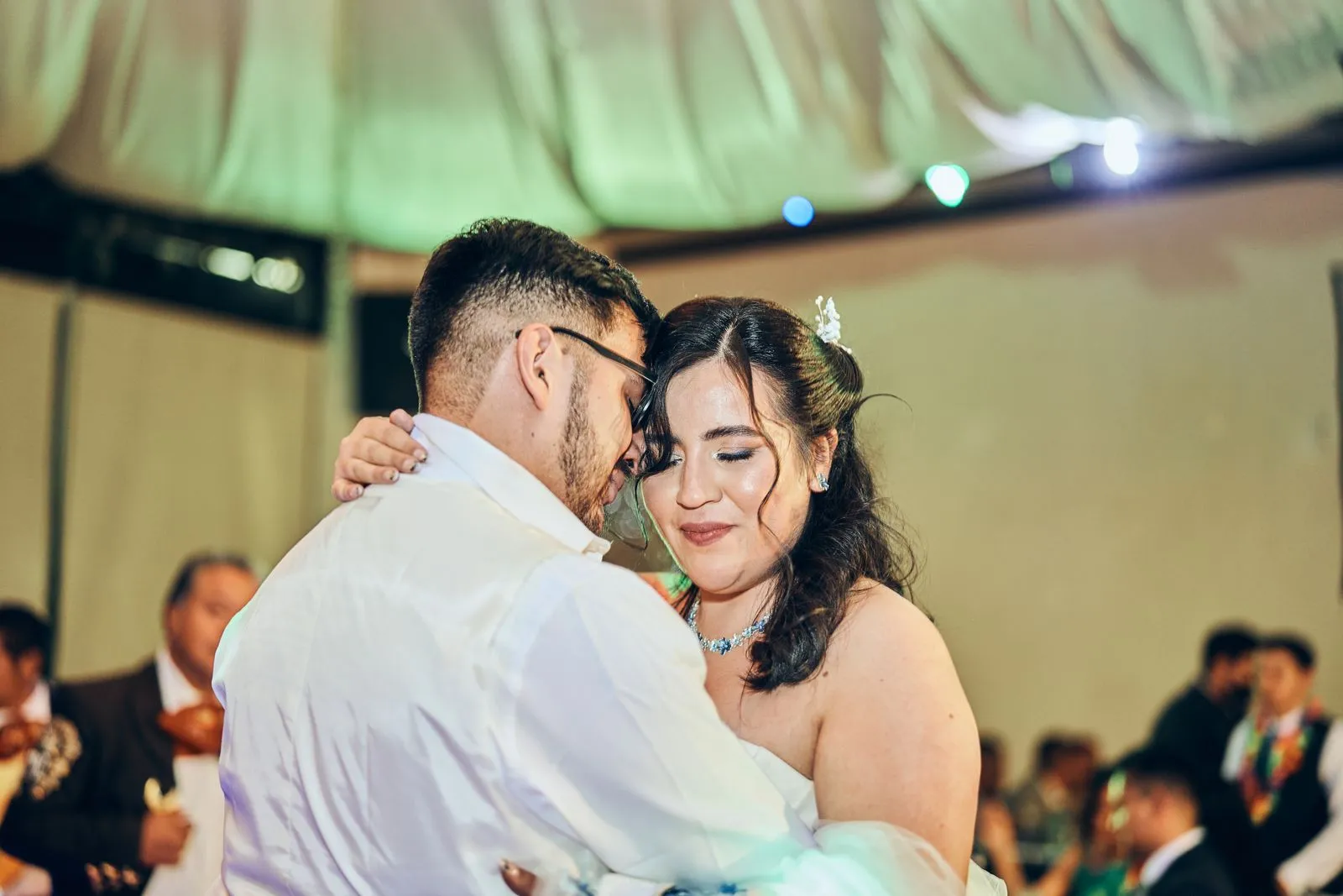 A joyous couple shares a tender dance during their wedding celebration.